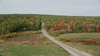 AX147_422 - 6K aerial stock footage flying by Old Ferry Road, approaching colorful forest, autumn, Wiscasset, Maine