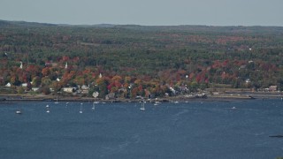AX148_002 - 6K aerial stock footage flying by a small waterfront town, autumn, Wiscasset, Maine
