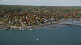 AX148_003E - 6K aerial stock footage flying over Sheepscot River, approaching small town, autumn, Wiscasset, Maine