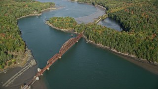AX148_006 - 6K aerial stock footage flying by a small bridge spanning Sheepscot River, autumn, Newcastle, Maine