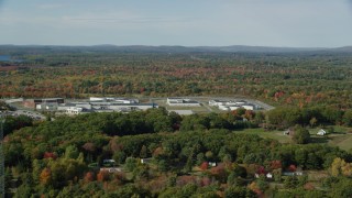 AX148_062 - 6k aerial stock footage orbiting Maine State Prison, colorful forest, autumn, Warren, Maine