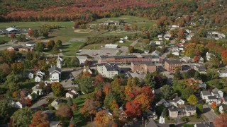 AX148_072 - 6K aerial stock footage flying by a small town, colorful trees, autumn, Thomaston, Maine