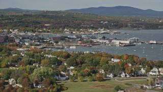 AX148_077E - 6K aerial stock footage flying by Rockland Harbor, small coastal town, autumn, Rockland, Maine