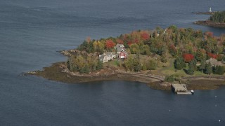 AX148_080 - 6K aerial stock footage flying by waterfront homes, colorful foliage, autumn, Owls Head, Maine