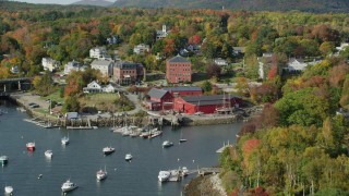 AX148_094 - 6k aerial stock footage flying over boats, Rockport Harbor, approach small coastal town, Rockport, Maine