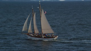 AX148_107 - 6k aerial stock footage orbiting a sailboat on West Penobscot Bay, Rockport, Maine