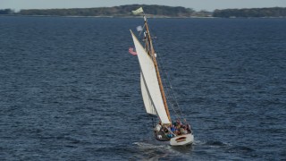 AX148_108 - 6k aerial stock footage orbiting a sailboat on West Penobscot Bay, Rockport, Maine