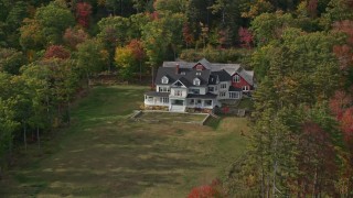 AX148_113 - 6K aerial stock footage approaching an isolated rural home, colorful foliage, autumn, Camden, Maine