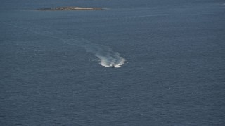 AX148_123 - 6K aerial stock footage tracking a boat on West Penobscot Bay, Camden, Maine