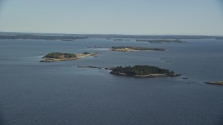 AX148_129E - 6K aerial stock footage approaching small islands, Hog Island, Maine