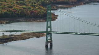AX148_145 - 6K aerial stock footage flying away from Deer Isle Bridge, autumn, Little Deer Isle, Maine