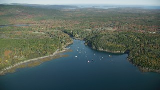 AX148_154 - 6k aerial stock footage approaching boats in Seal Cove, Mount Desert Island, autumn, Tremont, Maine