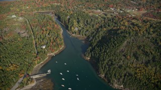 AX148_154E - 6K aerial stock footage flying over Seal Cove, Tremont Road, waterfront homes, autumn, Tremont, Maine