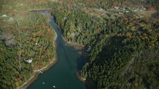 AX148_155 - 6k aerial stock footage flying over Seal Cove, Tremont Road, waterfront homes, autumn, Tremont, Maine