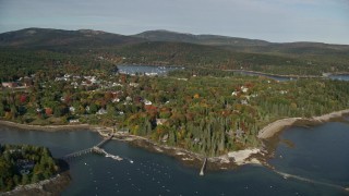 AX148_163E - 5.5K aerial stock footage flying by small coastal town in autumn, Northeast Harbor, Mount Desert Island, Maine