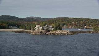 AX148_168E - 5.5K aerial stock footage flying by waterfront mansion, autumn, Seal Harbor, Mount Desert Island, Maine