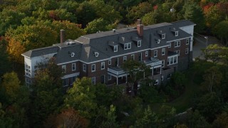 AX148_186 - 5.5K stock footage aerial video approaching waterfront mansion atop a rocky coastline, autumn, Bar Harbor, Maine