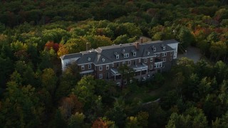 AX148_187 - 5.5K aerial stock footage flying by an isolated mansion, pan right, autumn, Bar Harbor, Maine