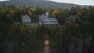 AX148_191 - 5.5K aerial stock footage flying by waterfront homes, autumn, Bar Harbor, Maine