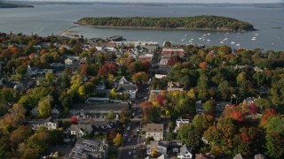 AX148_206E - 5.5K aerial stock footage flying toward harbor over Main Street in coastal town, autumn, Bar Harbor, Maine