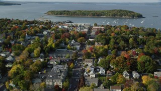 AX148_207 - 5.5K stock footage aerial video flying toward harbor over Main Street in coastal town, autumn, Bar Harbor, Maine