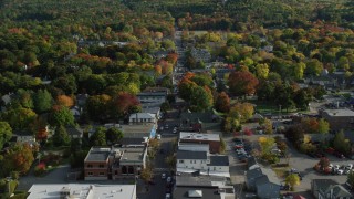 AX148_214 - 5.5K stock footage aerial video flying over Main Street of a small coastal town with fall foliage, Bar Harbor, Maine