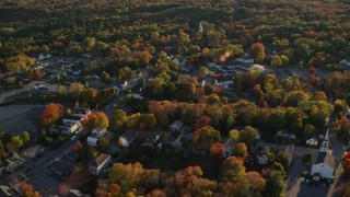 AX149_033 - 5.5K aerial stock footage flying over small coastal town homes and streets in autumn, Blue Hill, Maine