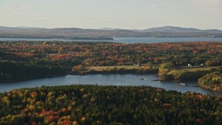 AX149_067 - 5.5K aerial stock footage flying by rural waterfront homes, Bagaduce River, forest, autumn, Penobscot, Maine