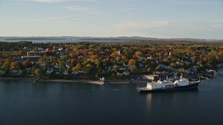 AX149_069E - 5.5K aerial stock footage flying by a small coastal town, State of Maine training ship, autumn, Castine, Maine