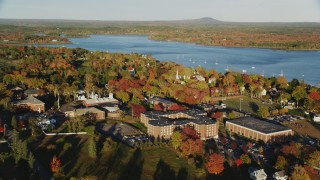 AX149_073 - 5.5K stock footage aerial video orbiting the Maine Maritime Academy among fall foliage, autumn, Castine, Maine