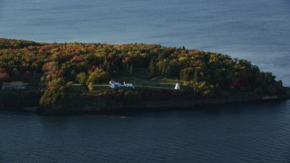 AX149_088 - 5.5K aerial stock footage flying by Fort Point Light, among fall foliage, autumn, Stockton Springs, Maine
