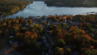 AX149_106 - 5.5K aerial stock footage orbiting a small coastal town on the Penobscot River, autumn, Bucksport, Maine