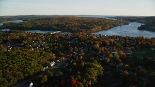AX149_110 - 5.5K aerial stock footage of a wide shot of a small town on the Penobscot River in autumn, Bucksport, Maine