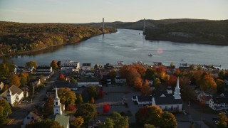 AX149_111E - 5.5K aerial stock footage approaching Penobscot Narrows Bridge from over small town, autumn, Bucksport, Maine