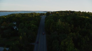 AX149_126 - 5.5K aerial stock footage flying over road, approach church, cemetery, autumn, Stockton Springs, Maine, sunset