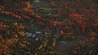 AX149_188 - 5.5K aerial stock footage flying by rural homes, Woodmans Mill Road, autumn, Liberty, Maine, sunset