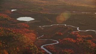 AX149_196 - 5.5K aerial stock footage flying by small rivers leading to a pond, autumn, Palermo, Maine, sunset