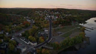 AX149_223 - 5.5K aerial stock footage approaching Saint Augustine Catholic Church, autumn, Augusta, Maine, twilight