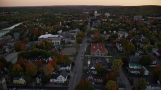 AX149_224E - 5.5K aerial stock footage approaching Memorial Circle, Maine State House, autumn, Augusta, Maine, twilight
