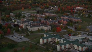 AX149_228E - 5.5K aerial stock footage flying by Maine government offices, autumn, Augusta, Maine, twilight