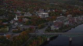 AX149_234E - 5.5K aerial stock footage flying by small bridge, downtown, Superior Court, autumn, Augusta, Maine, twilight