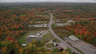 AX150_003 - 5.5K aerial stock footage approaching Western Avenue surrounded by colorful foliage, autumn, Manchester, Maine