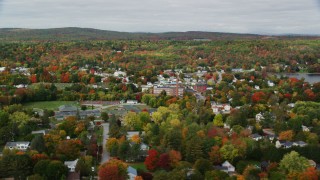 AX150_014 - 5.5K aerial stock footage flying by Winthrop Grade School, small town, autumn, Winthrop, Maine