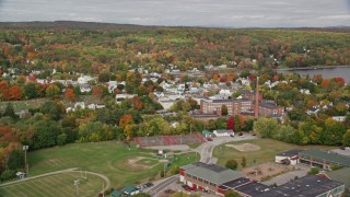 AX150_014E - 5.5K aerial stock footage flying by Winthrop Grade School, small town, autumn, Winthrop, Maine