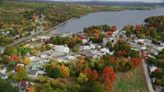AX150_015 - 5.5K aerial stock footage flying by a small town, school, sports fields, autumn, Winthrop, Maine