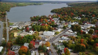 AX150_016 - 5.5K stock footage aerial video orbiting Winthrop United Methodist Church, small town, autumn, Winthrop, Maine