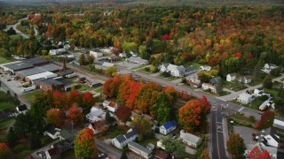 AX150_022 - 5.5K stock footage aerial video flying over small town, homes, factory, roads, autumn, Winthrop, Maine