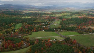 AX150_056 - 5.5K aerial stock footage flying by colorful first, Turner Street, rural homes, autumn, Buckfield, Maine