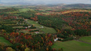 AX150_057 - 5.5K aerial stock footage flying by Turner Street, colorful foliage in autumn, Buckfield, Maine
