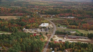 AX150_062 - 5.5K aerial stock footage flying over real homes, colorful trees, Depot Street, autumn, Buckfield, Maine